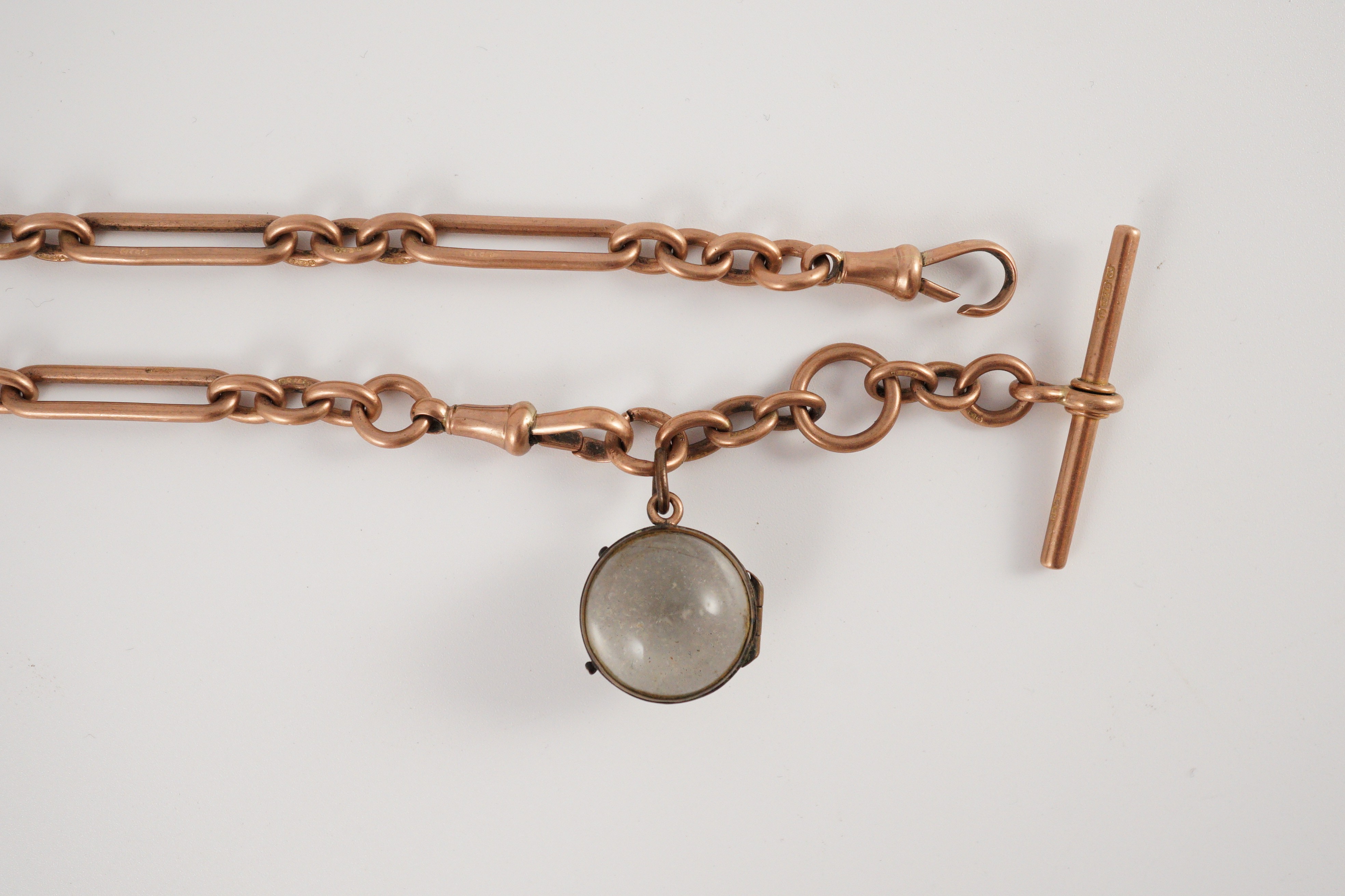 An early 20th century 9ct gold albert with magnified lens fob